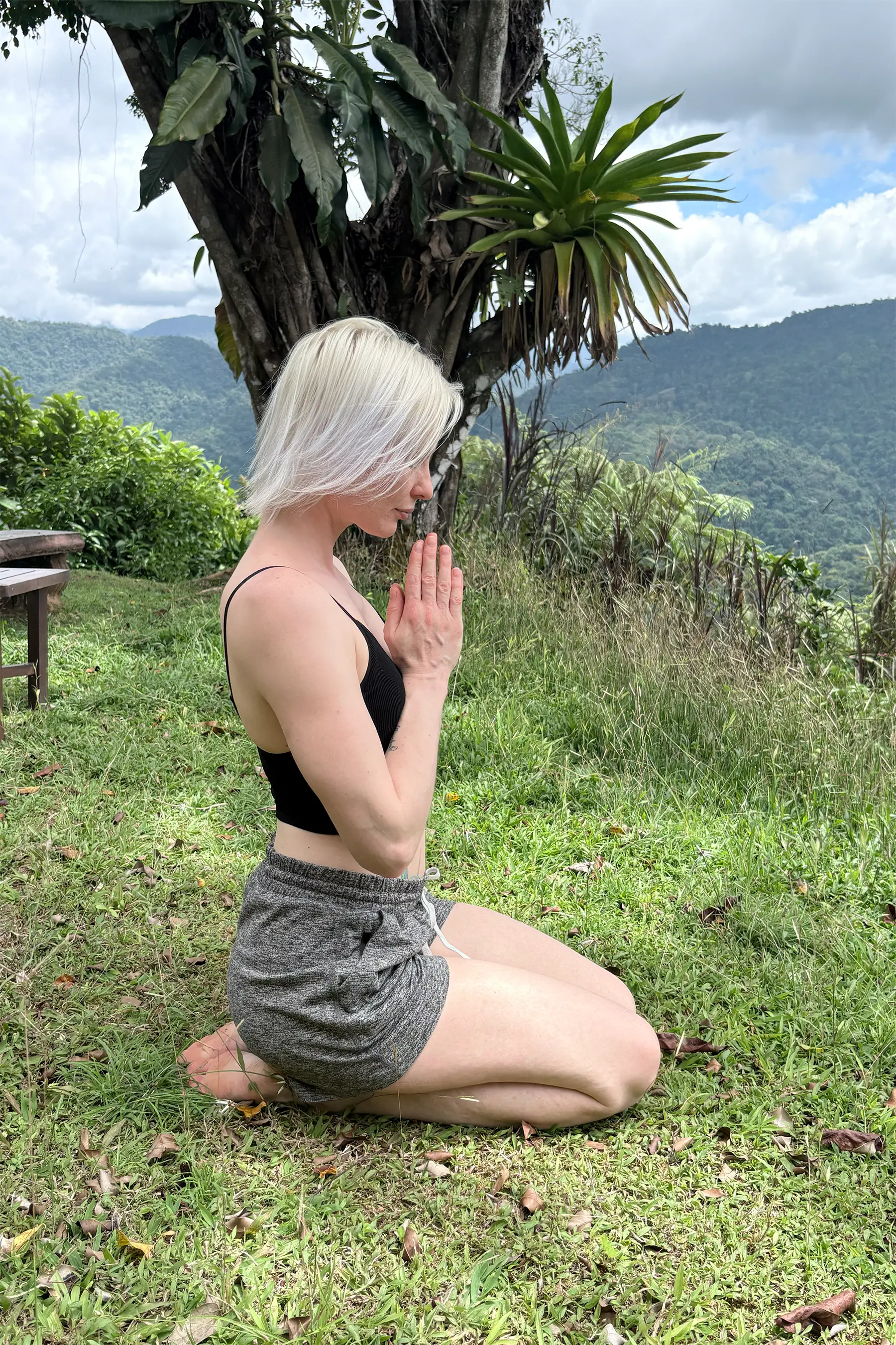 A woman practicing yoga meditation outdoors in nature.